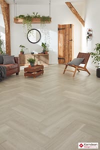 Light coloured Karndean Van Gogh Grey Brushed Oak flooring in a contemporary style living space with wooden framed furniture.