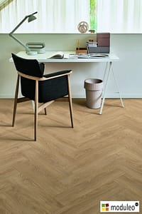 Moduleo Laurel Oak 51329 flooring in a modern style home office with a simple table and chair.
