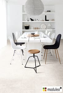 Moduleo Venetian Stone 46111 flooring in a contemporary style dinning room with a white rectangular wooden table and chairs.