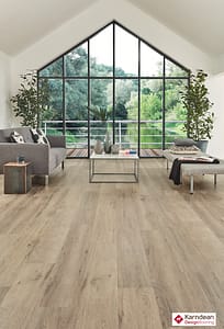 Light tan coloured Karndean Koriok Baltic Washed Oak flooring in a contemporary style living space with floor to ceiling feature window.