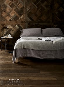 Dark coloured Ted Todd Classic Crafted Textures Salcey flooring in a contemporary style bedroom with wood covered walls.
