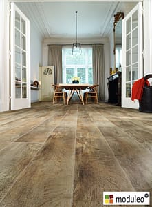 Moduleo Country Oak 54852 flooring in a traditional style living and dinning space with dividing French doors.