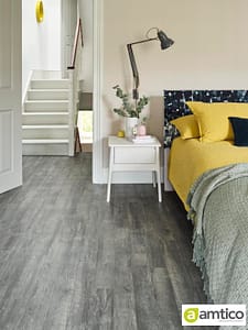 Amtico Spacia dark grey Drift Pine flooring with a thin plank pattern in a traditional style bedroom.