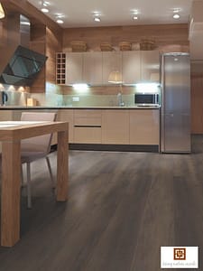 Dark coloured V4 Inglenook Hearth Oak laminate flooring in a modern kitchen with a wooden dining table and chairs.