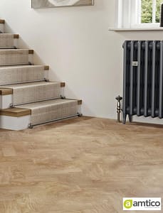 Amtico Signature Fawn Oak effect flooring with a parquet pattern at the foot of a traditional style stairway.