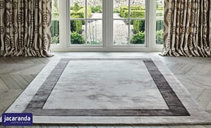 Mixed grey Jacaranda Simla boardered grey and pewter rug in a contemporary style room in front of tradition style French doors.