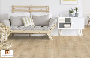 Light tan coloured V4 Sunwashed Oak Laminate flooring in a modern living room with wooden framed furniture and a low level white storage bureau.