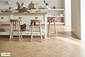 Amtico Form light brown Eventide Oak flooring with a small parquet pattern in a rustic kitchen setting.
