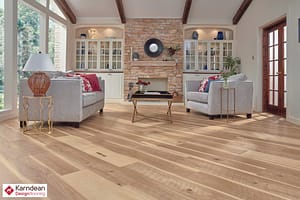 Mixed tan coloured Karndean Art Select Classic wood Hickory flooring in a rustic style living space and a low backed grey sofa and chair set.