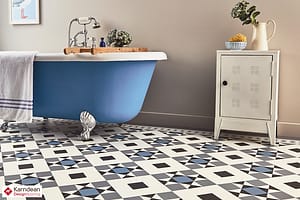 Blue and white Karndean Clif Heritage flooring in a traditional style bathroom featuring a blue roll top bath tub and a small cream wooden cabinet.