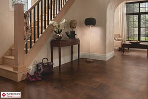 Dark coloured Karndean Da Vinci Iron Ore flooring in a traditional style residential entrance hall featuring a small brown wooden narrow table.