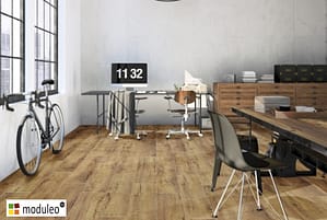 Moduleo Mountain Oak 56440 flooring in a loft style work space with a push bike against one wall.