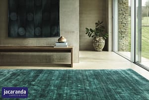Jacaranda Almora Jade rug in a contemporary style room in front of sliding glass patio doors.
