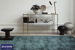 Turquoise Jacaranda Satara Agate rug in front of a contemporary style display table.