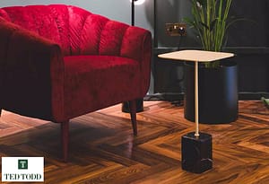 Dark brown Coloured Ted Todd Morado Darwin flooring in a contemporary style setting under a burgundy coloured low backed arm chair.