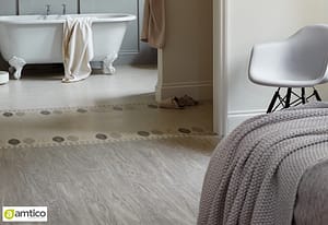 Amtico Signature light grey wood planking effect flooring in a bedroom setting.